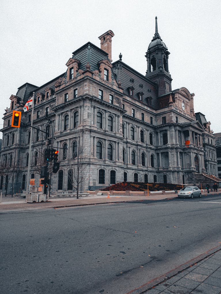 Historic Montreal City Hall with an urban street view in winter, showcasing classic architecture.