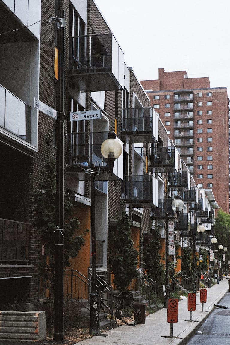 Street view of modern apartment buildings in Montreal's urban area with a Lavers street sign.