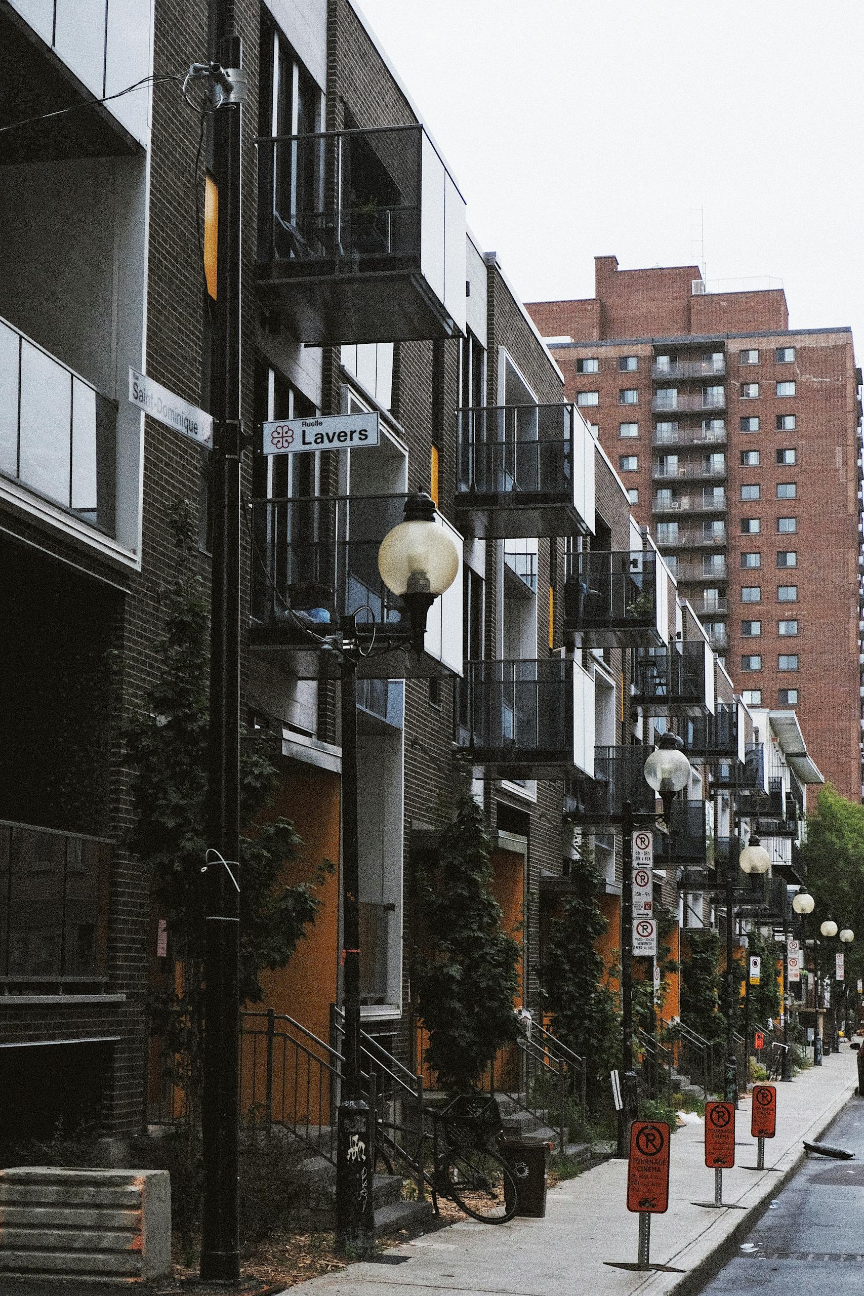 Street view of modern apartment buildings in Montreal's urban area with a Lavers street sign.